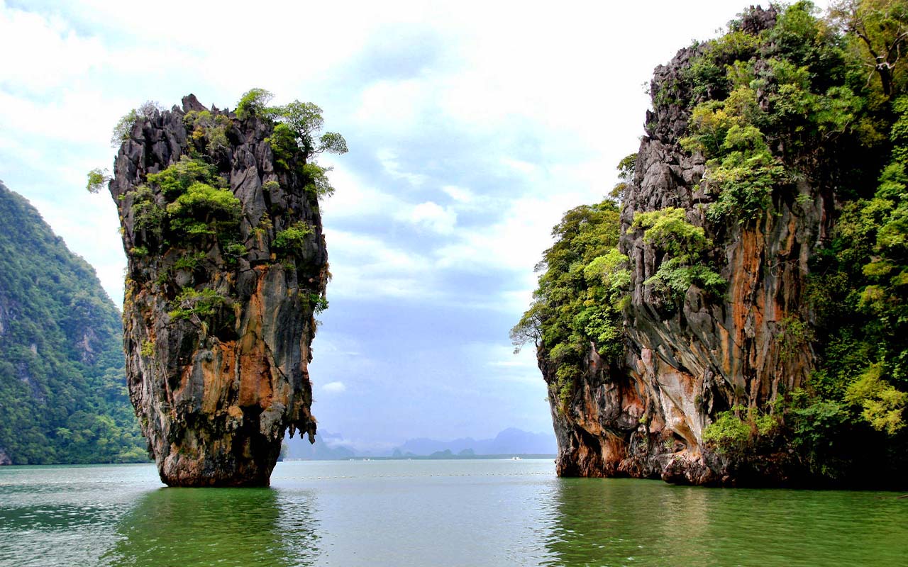 Limestone karst island of James Bond Island rising from emerald waters in Phang Nga Bay, Thailand