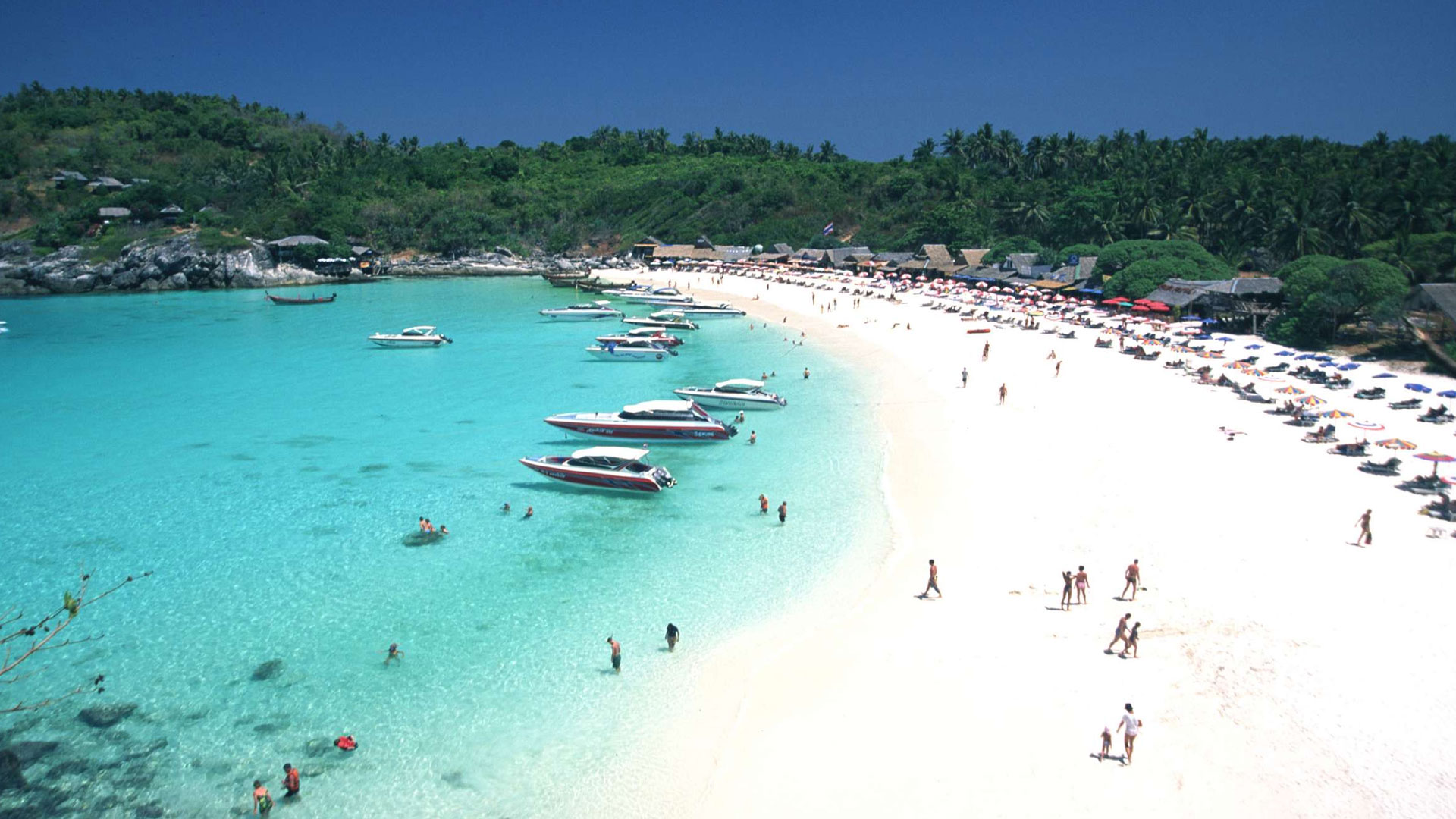 A beautiful beach in Phuket with palm trees and turquoise water